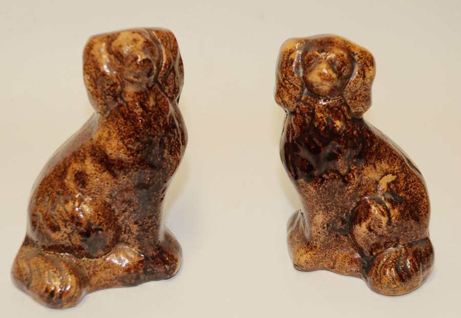 A Pair Of Early 19th Century Treacle Glazed Rockingham Pottery Spaniel