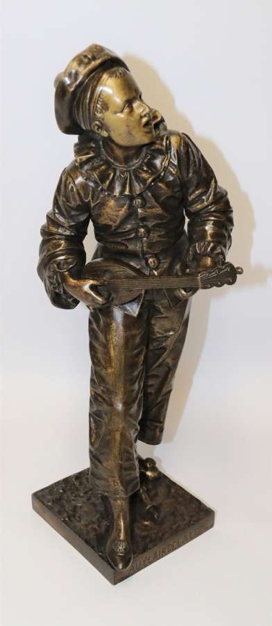 A French Bronze Sculpture Of A Pierrot Singing and playing the lute