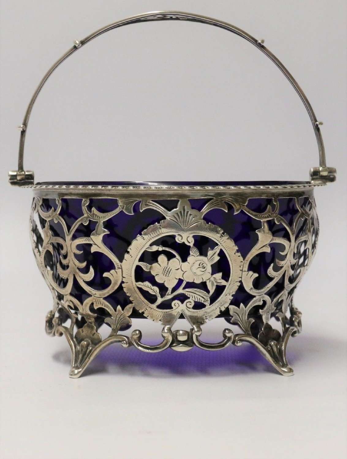 Edwardian period silver sugar basket with original blue glass liner