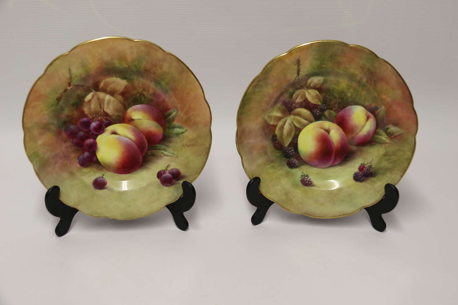 A pair of hand painted fruit plates by R Budd Worcester