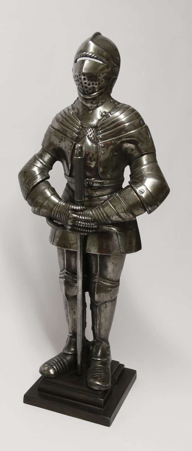 Fire side poker stand in the form of a medieval knight, circa 1920