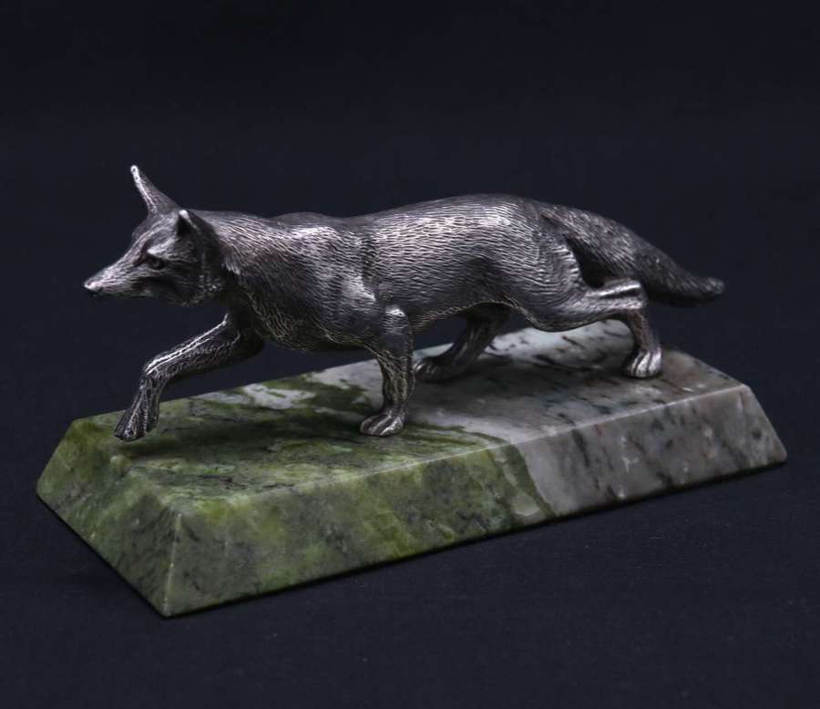 A finely detailed silvered bronze study of a fox on a marble base