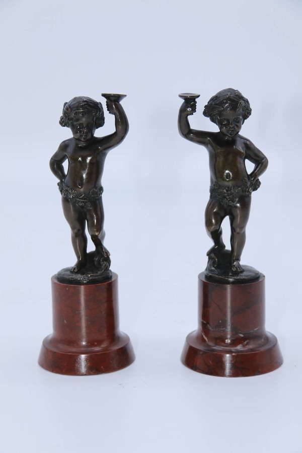 A pair of 19th century bronze putti figures on marble bases circa 1860