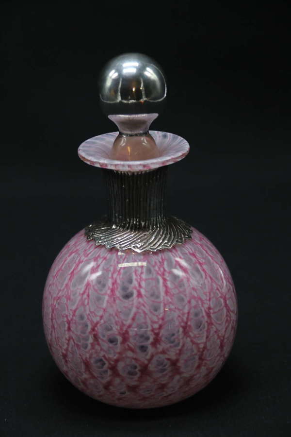 A most unusual 1930s art glass and silver mounted perfume bottle.