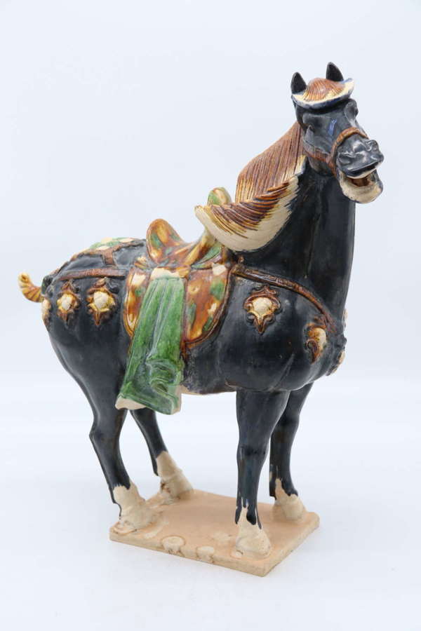 A large Chinese Tang Dynasty style Sancai glazed pottery horse.