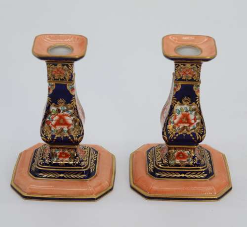 A pair of hand painted Royal Crown Derby candlesticks, circa 1911