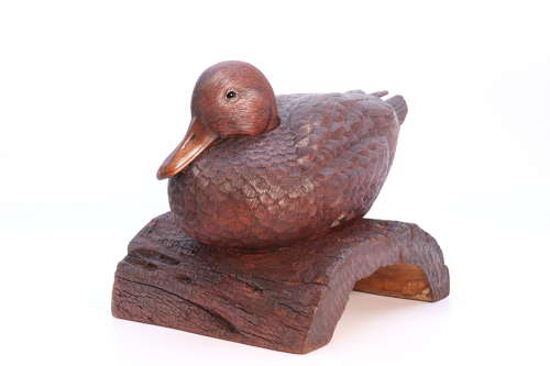 A Black Forest linden wood study of a perched mallard duck