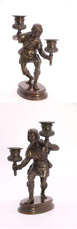 A pair of French 19th century bronze figurative candlesticks c 1860