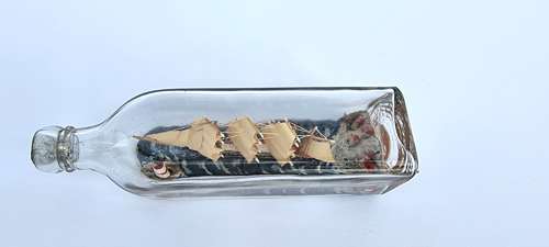 A four mast 18th century ship in a bottle, English folk art.