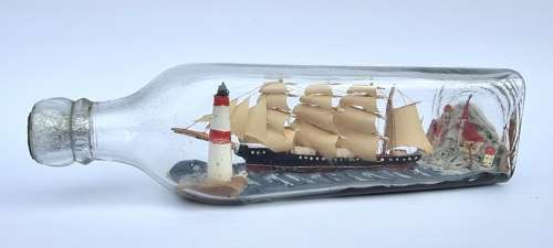 A four mast 18th century ship in a bottle, English folk art.