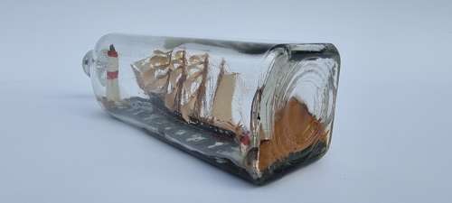 A four mast 18th century ship in a bottle, English folk art.