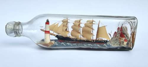 A four mast 18th century ship in a bottle, English folk art.