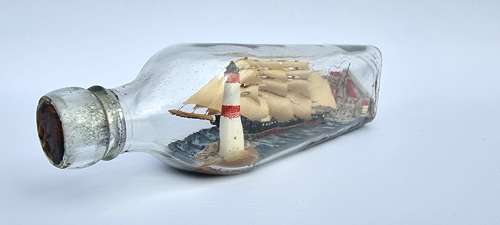 A four mast 18th century ship in a bottle, English folk art.