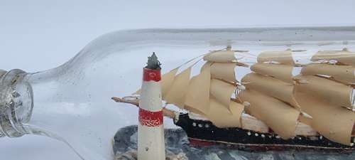 A four mast 18th century ship in a bottle, English folk art.
