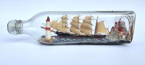A four mast 18th century ship in a bottle, English folk art.