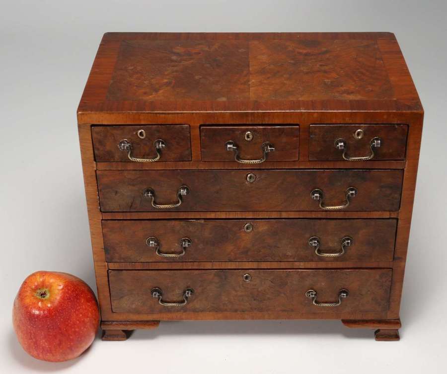A superb miniature George II style figured walnut chest of drawers.