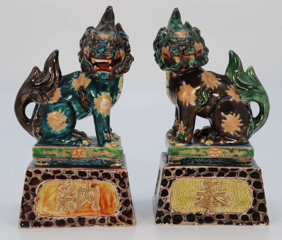 A pair of Chinese hand painted pottery Buddhist lions circa 1900.