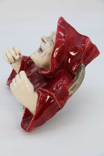 An Austrian pottery wall hanging candelabra in the form of a monk.