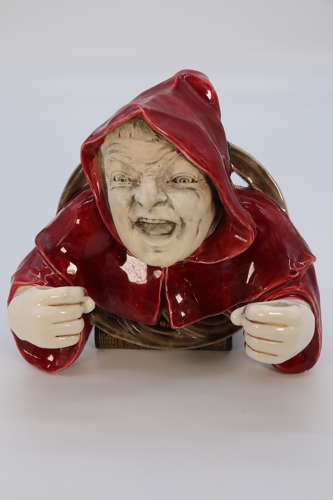 An Austrian pottery wall hanging candelabra in the form of a monk.