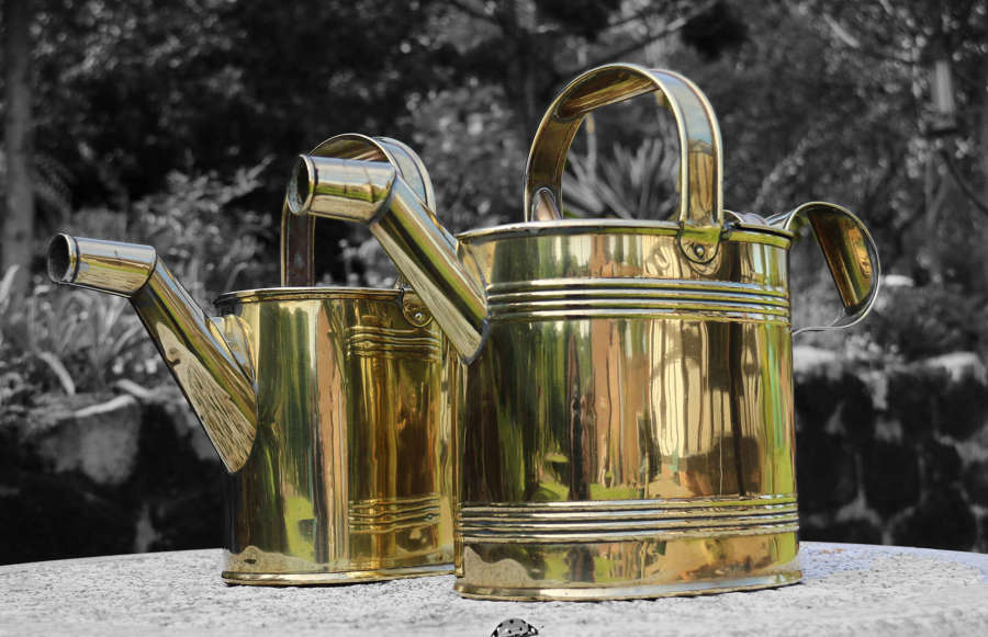 A matched pair of late 19th century brass watering cans circa 1900