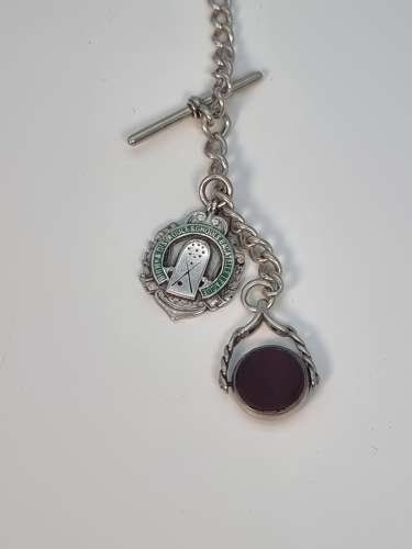 A solid silver pocket watch, presentation case and chain with two fobs