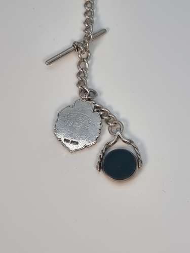 A solid silver pocket watch, presentation case and chain with two fobs
