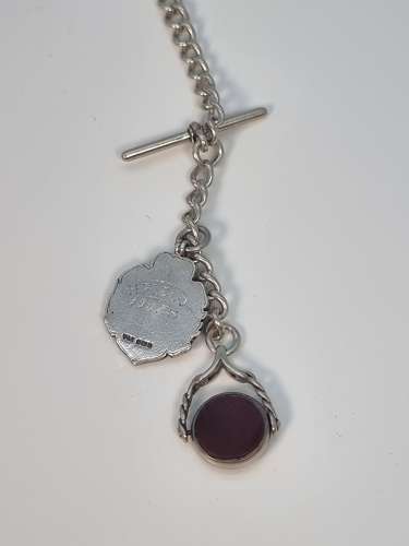 A solid silver pocket watch, presentation case and chain with two fobs