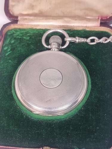 A solid silver pocket watch, presentation case and chain with two fobs
