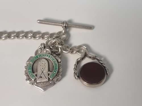 A solid silver pocket watch, presentation case and chain with two fobs
