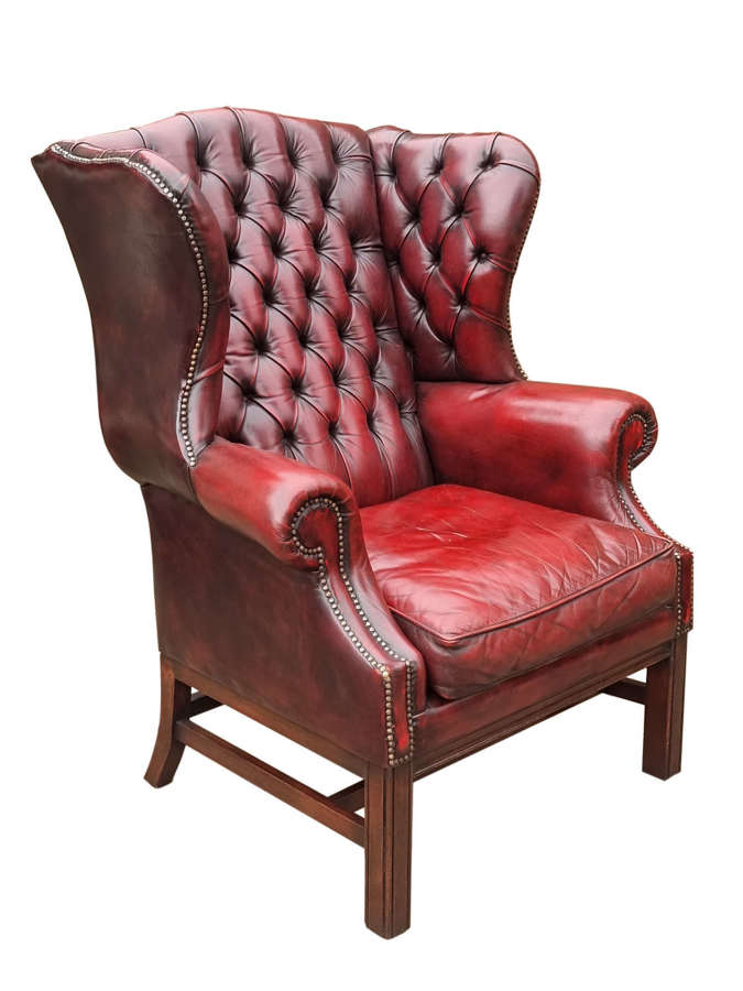 A George III style oversized deep buttoned leather winged armchair