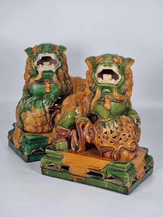 Chinese pottery foo dogs, a large pair with sancai glaze circa 1900