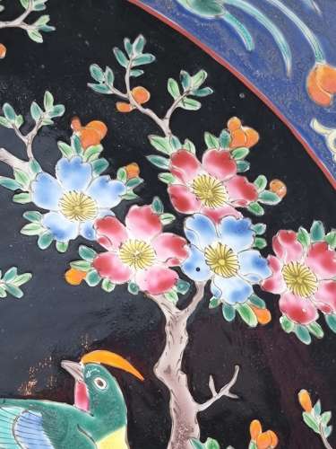 A large Chinese wall charger in famille noire porcelain