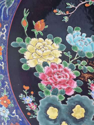 A large Chinese wall charger in famille noire porcelain