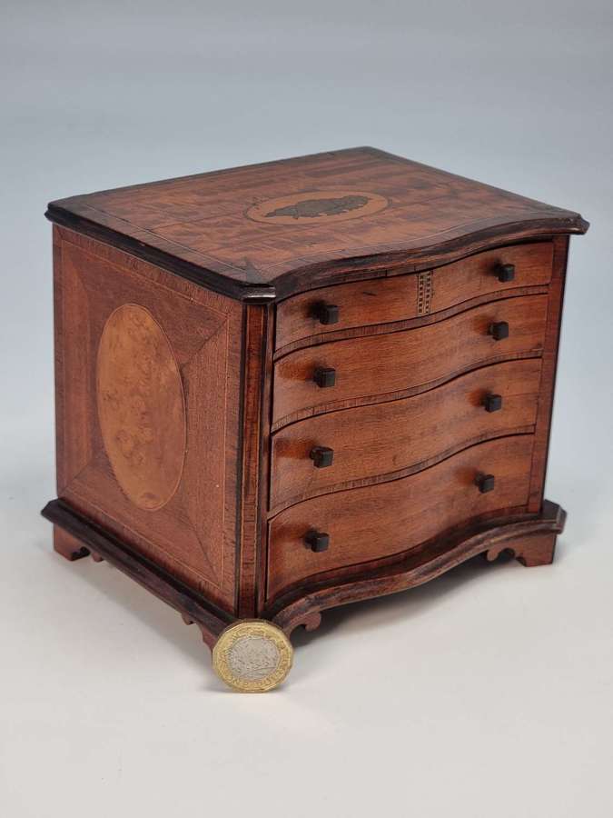 A miniature 18th century style serpentine chest of drawers, circa 1900