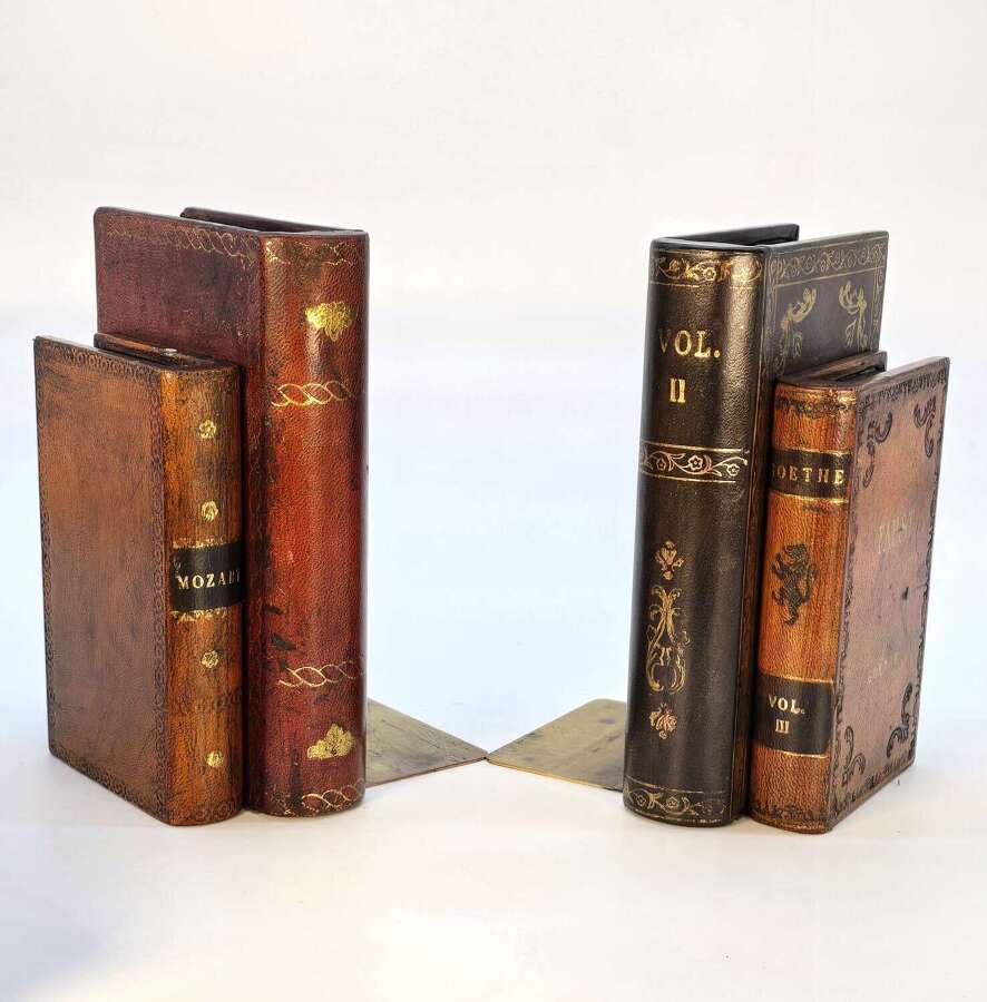 A pair of bookends made in the form of antique leather bound books.