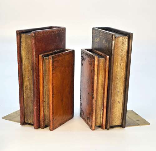 A pair of bookends made in the form of antique leather bound books.