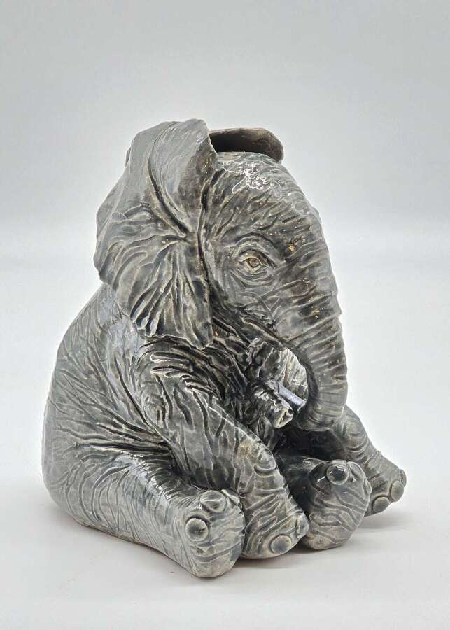 Antique glazed pottery sculpture of a baby elephant made in 1928