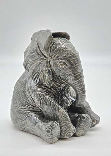 Antique glazed pottery sculpture of a baby elephant made in 1928