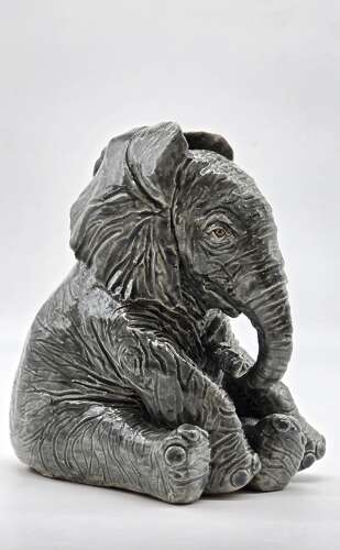 Antique glazed pottery sculpture of a baby elephant made in 1928
