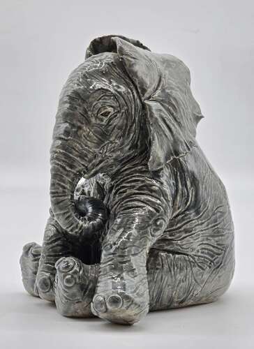 Antique glazed pottery sculpture of a baby elephant made in 1928
