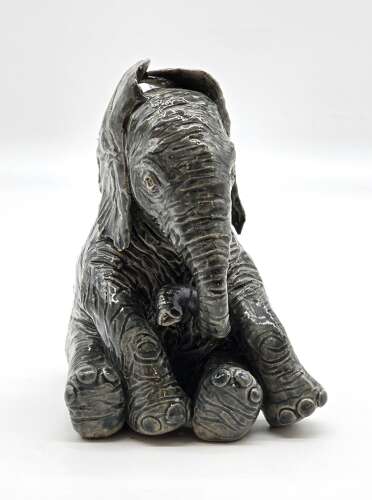 Antique glazed pottery sculpture of a baby elephant made in 1928