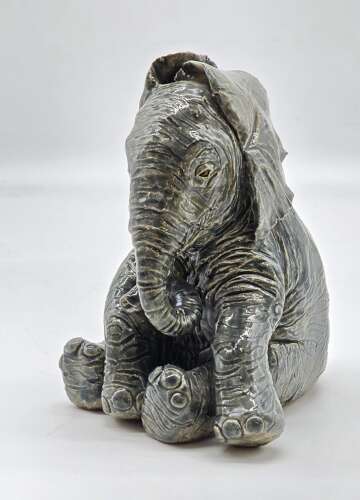 Antique glazed pottery sculpture of a baby elephant made in 1928