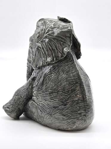Antique glazed pottery sculpture of a baby elephant made in 1928