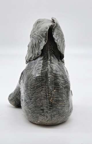 Antique glazed pottery sculpture of a baby elephant made in 1928