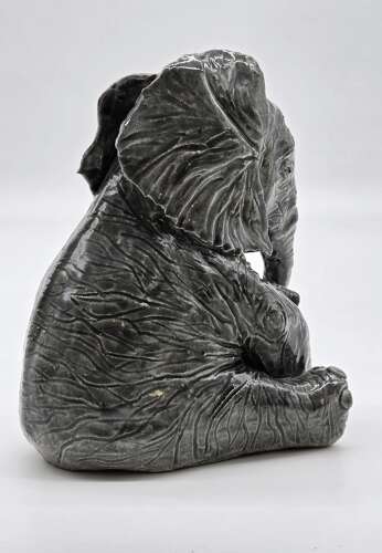 Antique glazed pottery sculpture of a baby elephant made in 1928