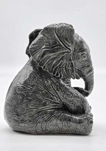 Antique glazed pottery sculpture of a baby elephant made in 1928