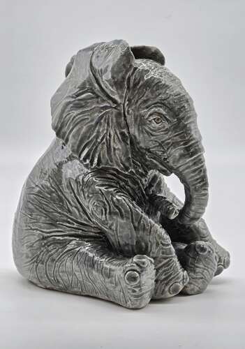 Antique glazed pottery sculpture of a baby elephant made in 1928