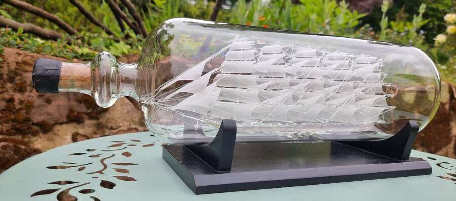 An exceptionally large hand blown glass model ship in a bottle.