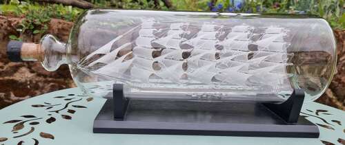An exceptionally large hand blown glass model ship in a bottle.