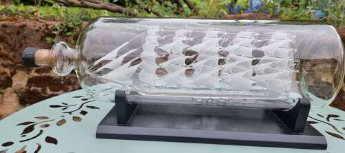 An exceptionally large hand blown glass model ship in a bottle.